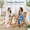 Acacia wood patio set moved to the side of a small patio to free up floor space
