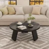 Round coffee table paired with a compact sofa in a small apartment living space