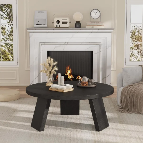 Three-leg base of the round coffee table with inclined legs on a living room rug