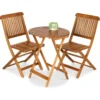 Three-piece acacia wood patio set with two chairs and a round table on a balcony