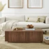 Mid century modern fluted coffee table shown in a living room beside a sofa