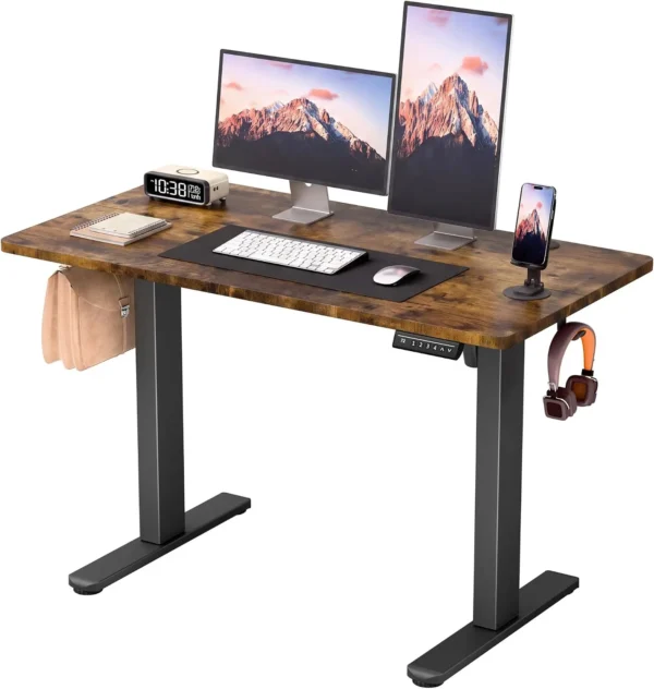 Small electric standing desk with a 45 by 24 inch desktop in a compact home office