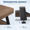 Wood-look tabletop surface on a sturdy metal frame, close-up detail