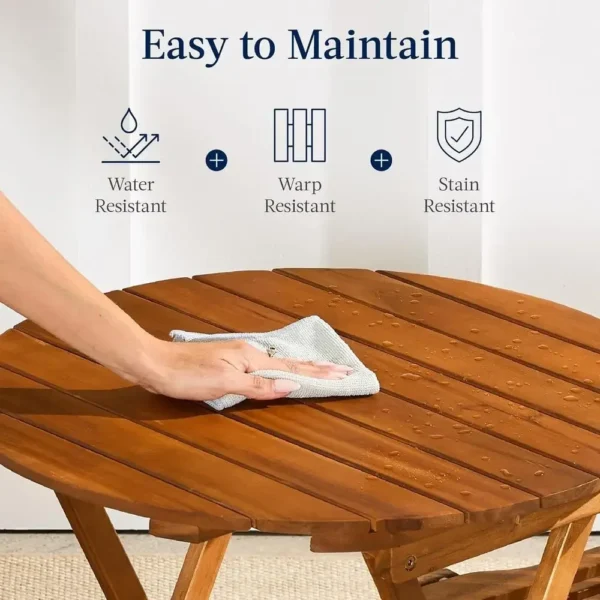 Close-up of the sealed light teak finish and open-slat tabletop of the wood outdoor table and chairs